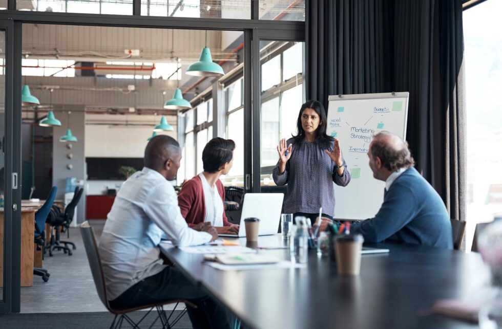 a woman giving a presentation to a group of people