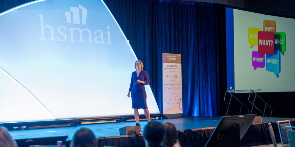 a woman standing on a stage in front of a crowd